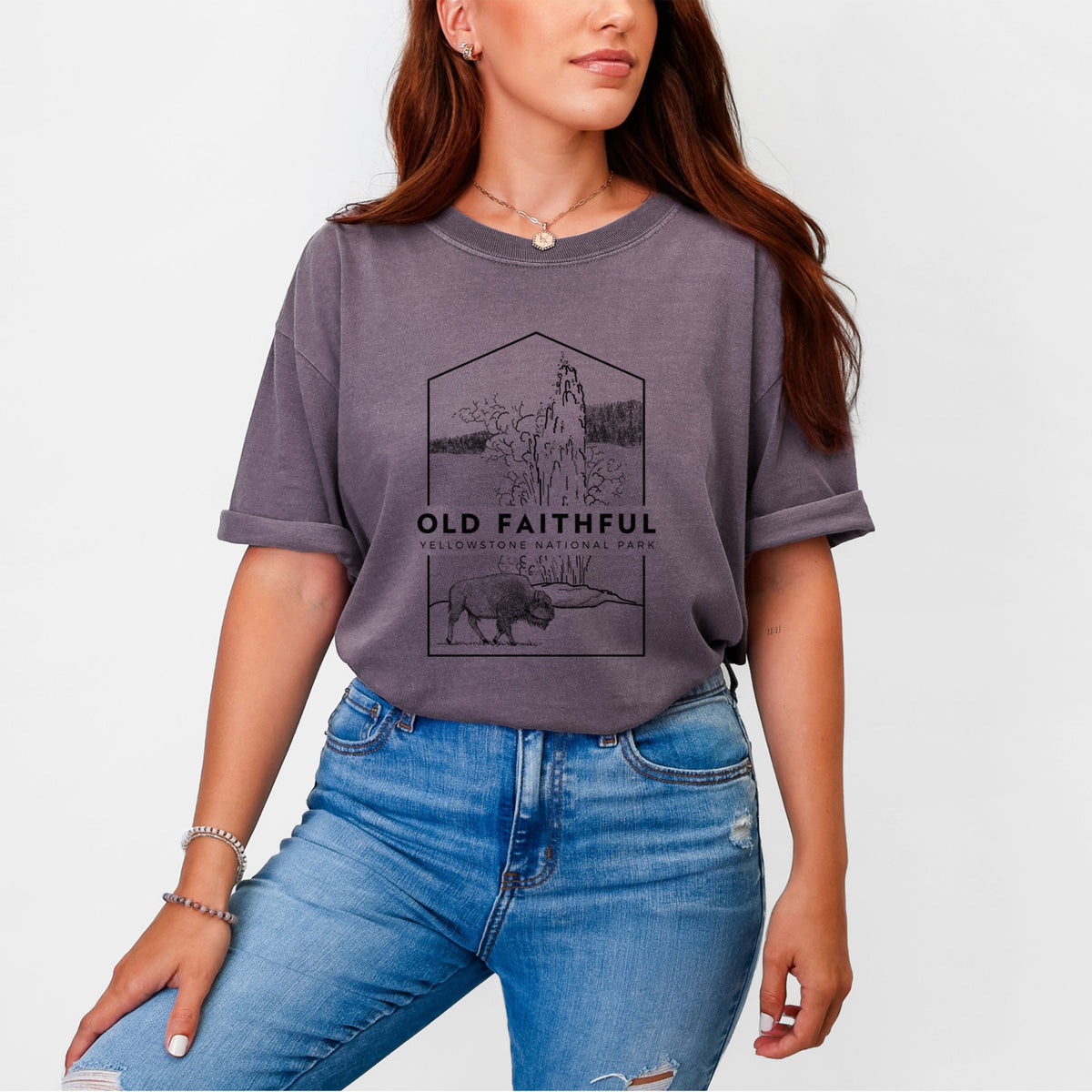 Woman wearing a Comfort Colors t-shirt printed with a black line art badge of the Old Faithful geyser erupting with a bison nearby, with the words Old Faithful, Yellowstone National Park.