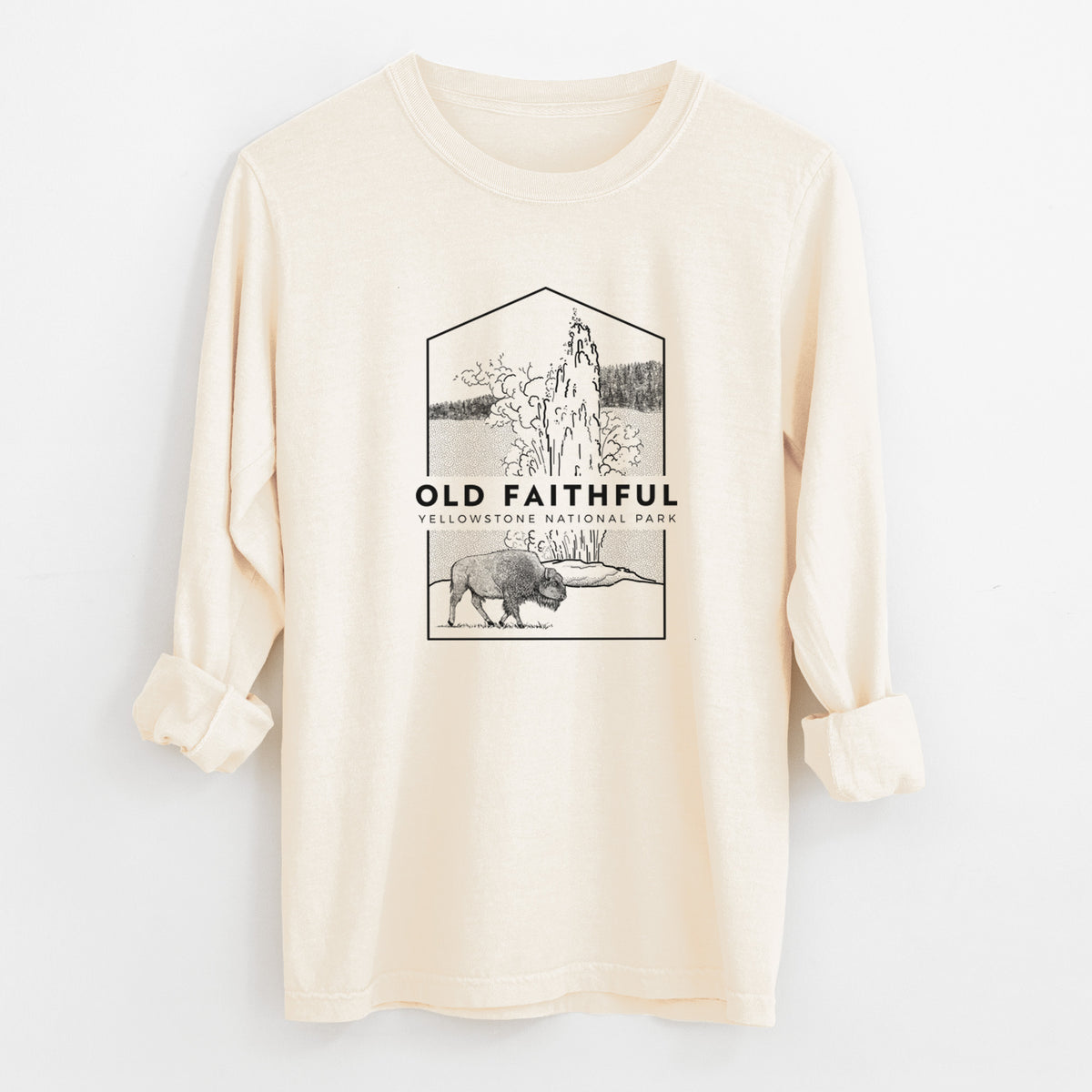 Ivory Comfort Colors long sleeve shirt laid flat with the cuffs rolled, printed with a black line art badge of the Old Faithful geyser erupting with a bison nearby, with the words Old Faithful, Yellowstone National Park.