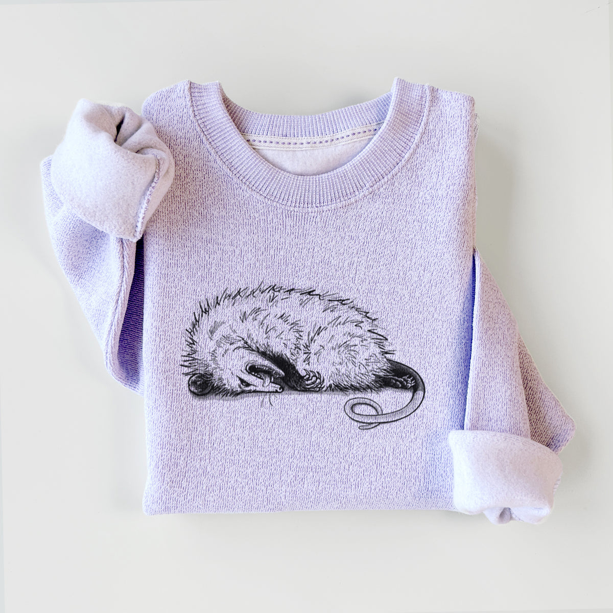 Ice purple knit sweatshirt printed with a black ink illustration of an opossum lying on its side playing dead, styled flat.