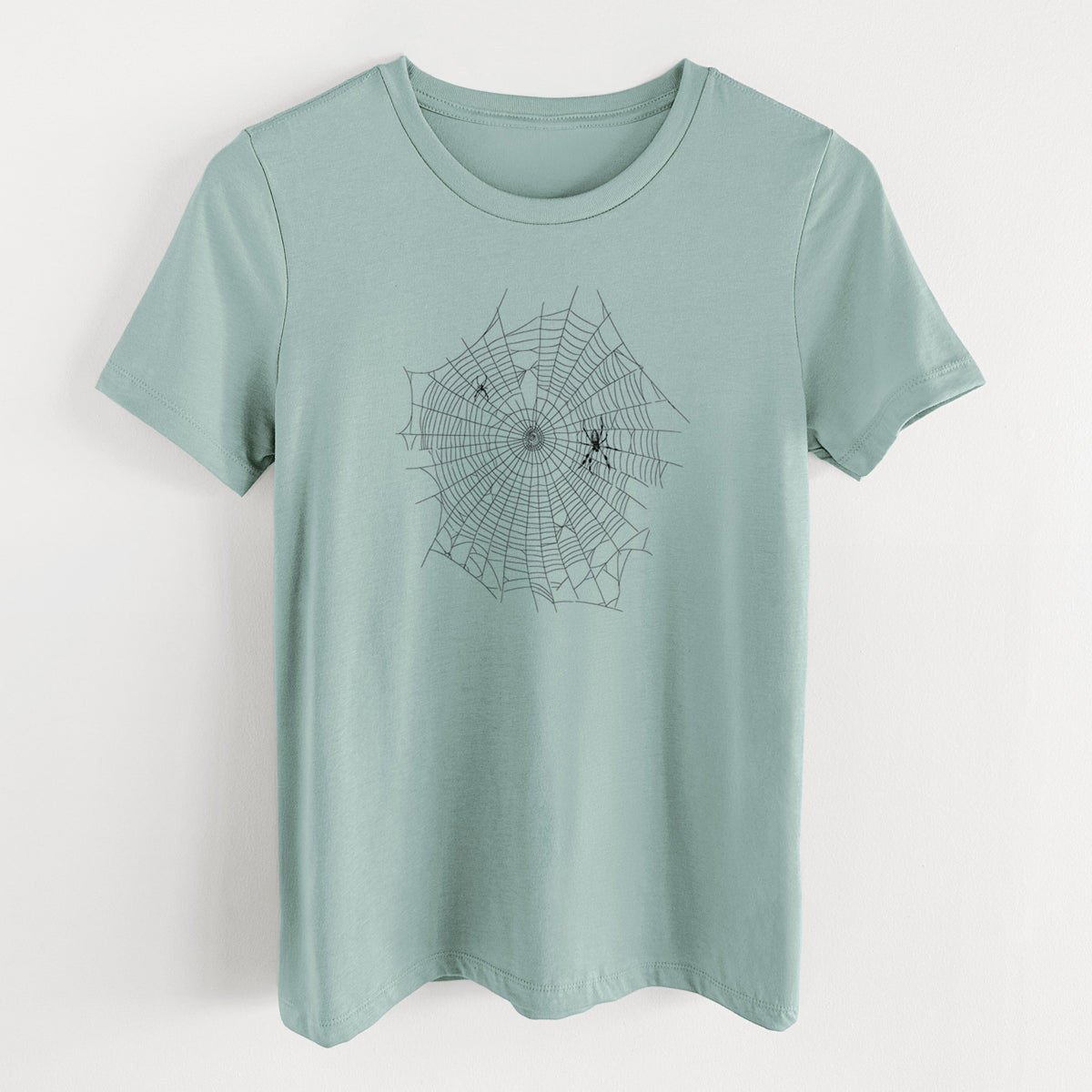 Dusty blue women's relaxed fit cotton t-shirt laid flat, printed with a black ink line drawing of an orb weaver spider in the center of its web.