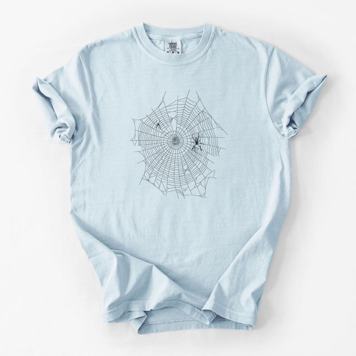 Chambray blue Comfort Colors t-shirt laid flat, printed with a black ink line drawing of an orb weaver spider in the center of its web.