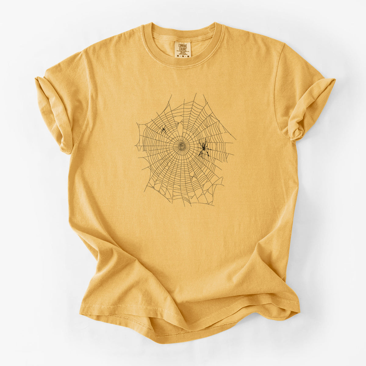 Golden wheat yellow Comfort Colors t-shirt laid flat, printed with a black ink line drawing of an orb weaver spider in the center of its web.