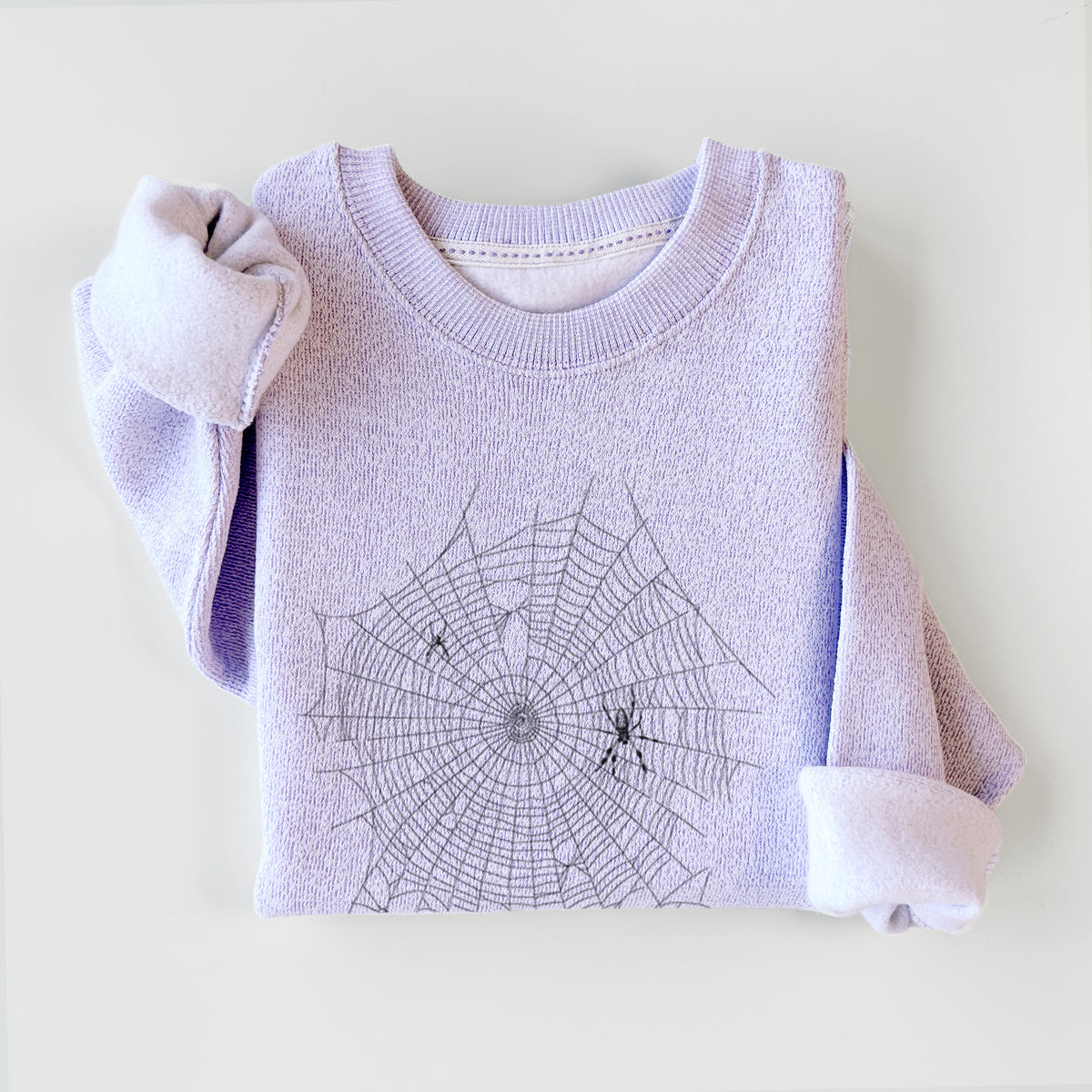 Ice purple knit sweatshirt printed with a black ink line drawing of an orb weaver spider in the center of its web, styled flat.