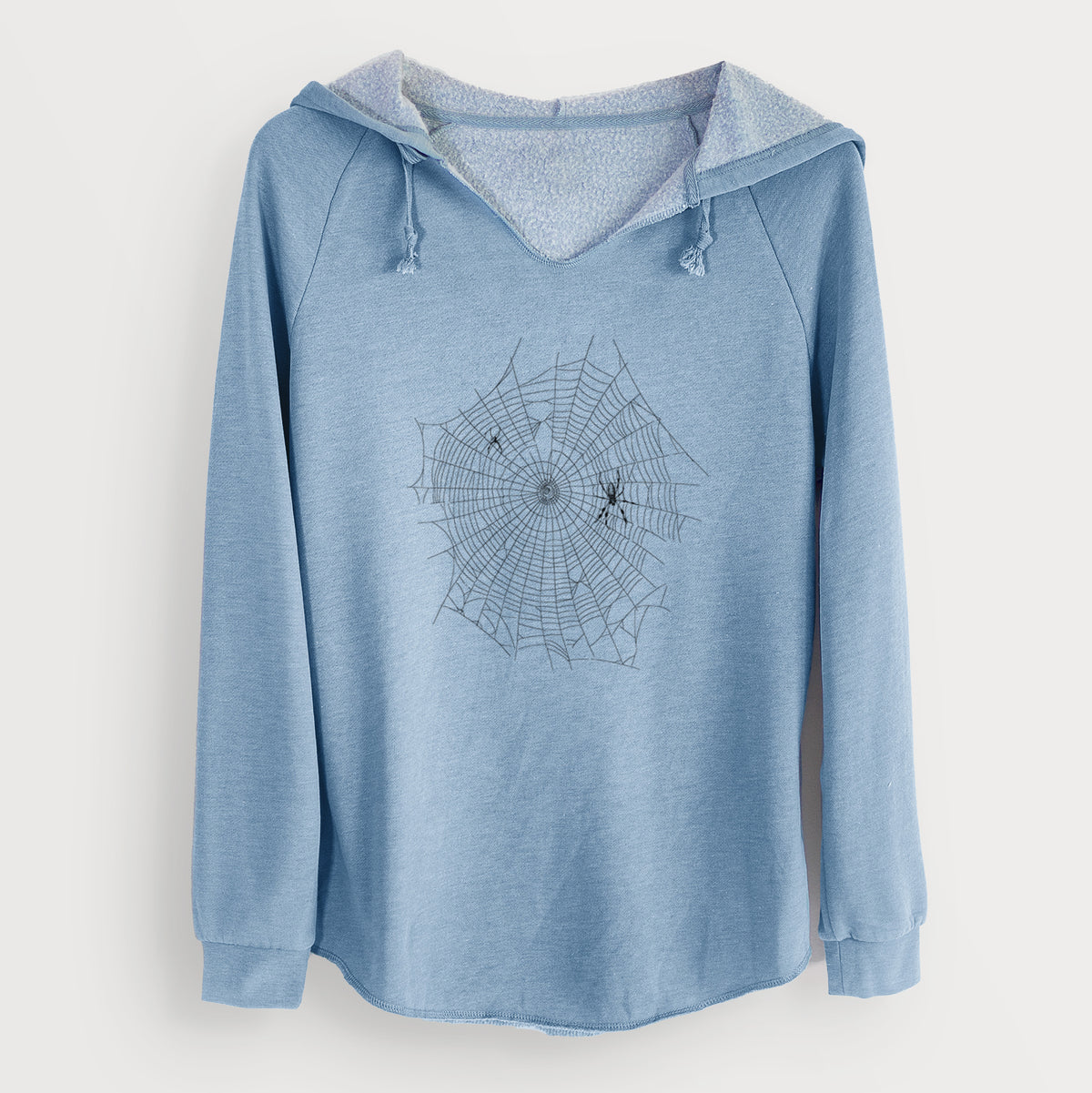 Misty blue women's Cali Wave hooded sweatshirt laid flat, printed with a black ink line drawing of an orb weaver spider in the center of its web.