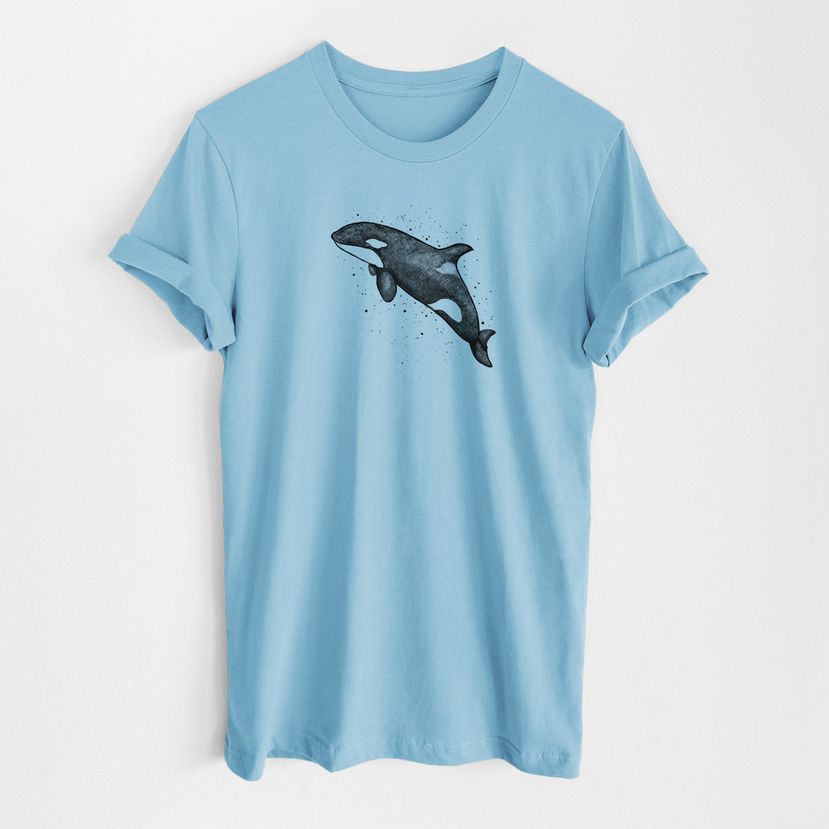 Ocean blue lightweight cotton t-shirt laid flat, printed with a black ink illustration of an orca leaping, with ink splatters.