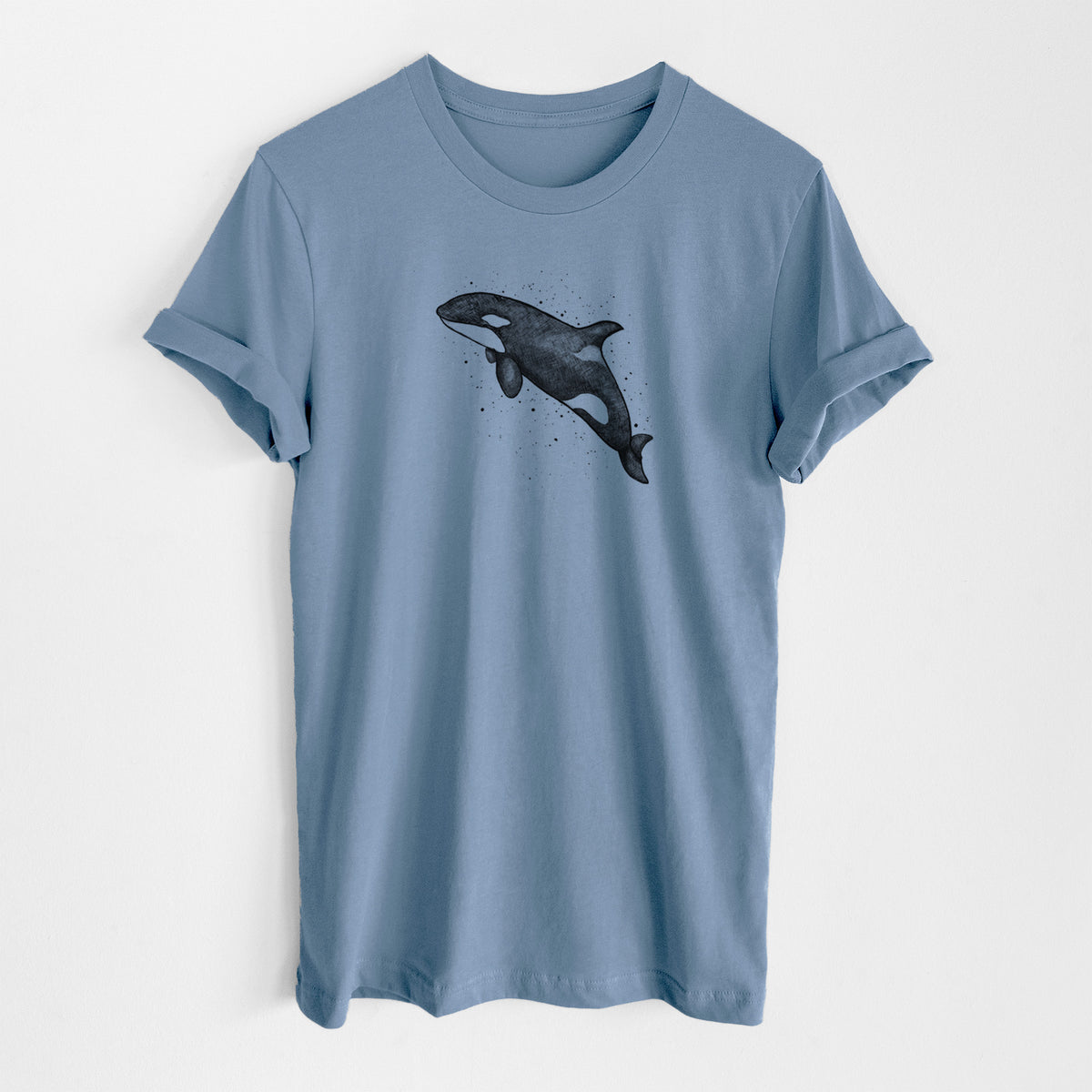 Steel blue lightweight cotton t-shirt laid flat, printed with a black ink illustration of an orca leaping, with ink splatters.