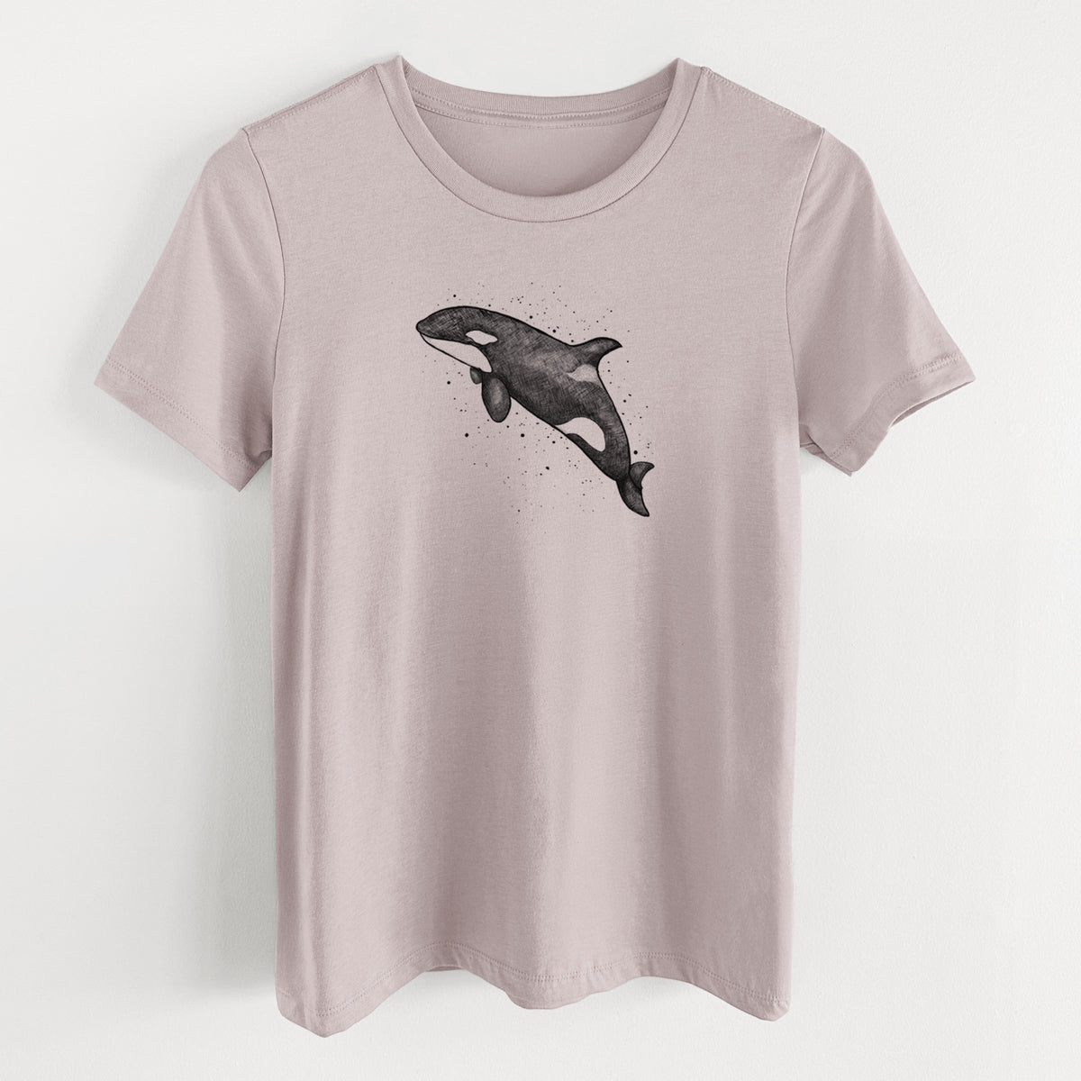 Pink gravel women's relaxed fit cotton t-shirt laid flat, printed with a black ink illustration of an orca leaping, with ink splatters.