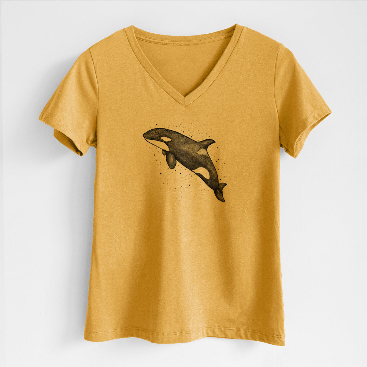 Honeycomb yellow women's relaxed fit cotton V-neck t-shirt laid flat, printed with a black ink illustration of an orca leaping, with ink splatters.