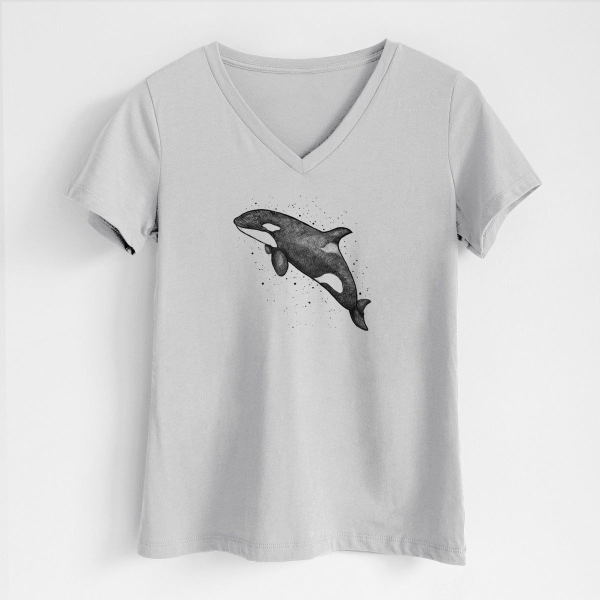 Lunar grey women's relaxed fit cotton V-neck t-shirt laid flat, printed with a black ink illustration of an orca leaping, with ink splatters.