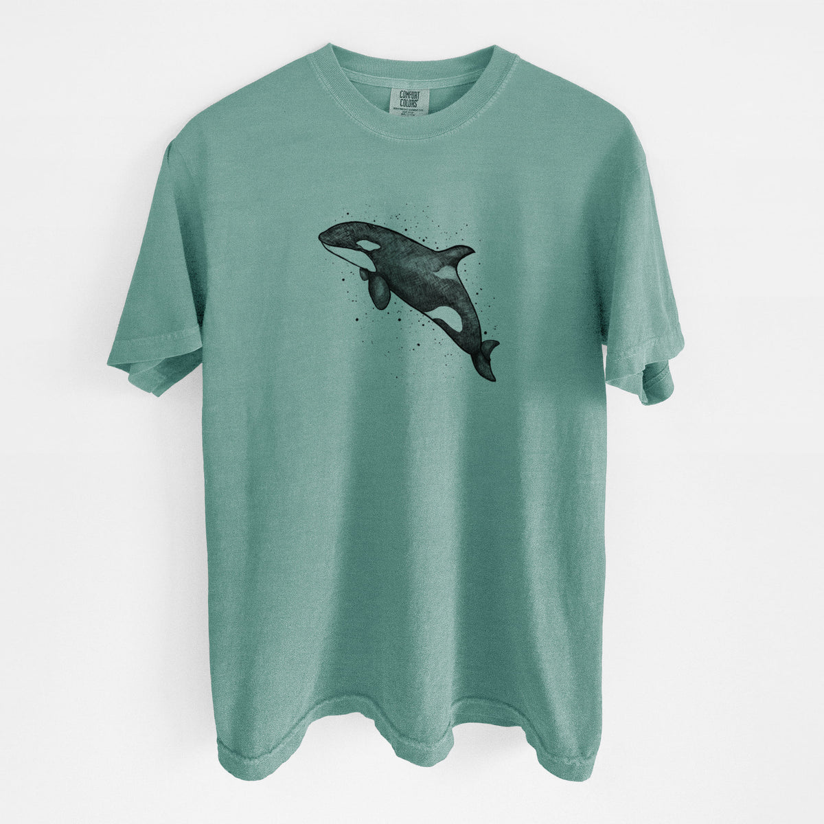 Reef green Comfort Colors t-shirt laid flat, printed with a black ink illustration of an orca leaping, with ink splatters.