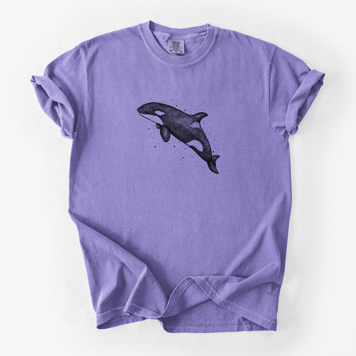 Violet purple Comfort Colors t-shirt laid flat, printed with a black ink illustration of an orca leaping, with ink splatters.
