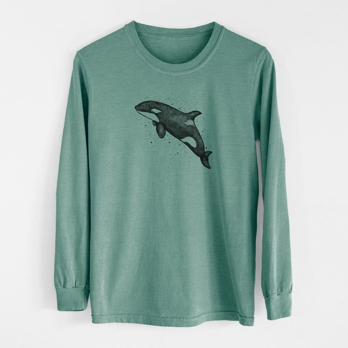 Pine green Comfort Colors long sleeve shirt laid flat, printed with a black ink illustration of an orca leaping, with ink splatters.