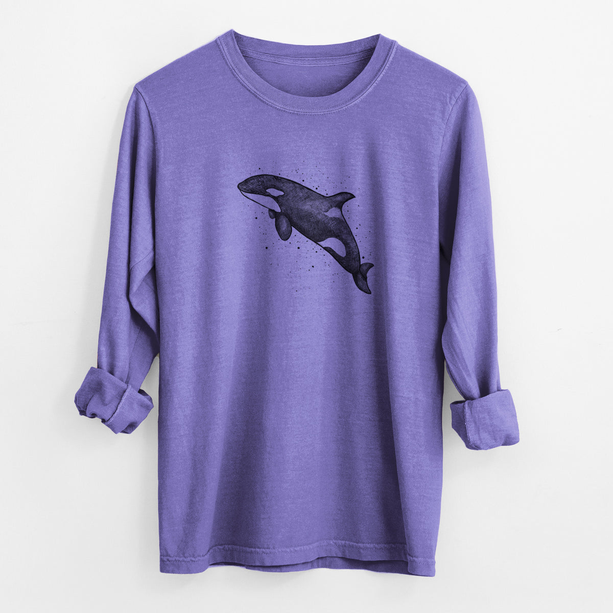 Violet purple Comfort Colors long sleeve shirt laid flat with the cuffs rolled, printed with a black ink illustration of an orca leaping, with ink splatters.