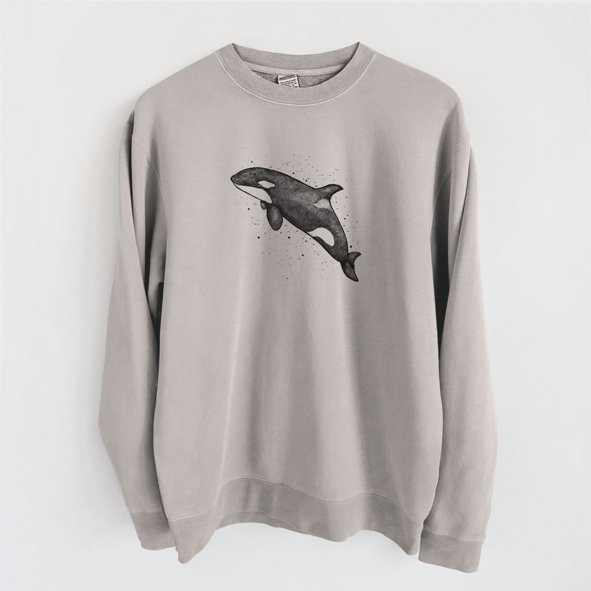 Cement grey pigment dyed crewneck sweatshirt laid flat, printed with a black ink illustration of an orca leaping, with ink splatters.