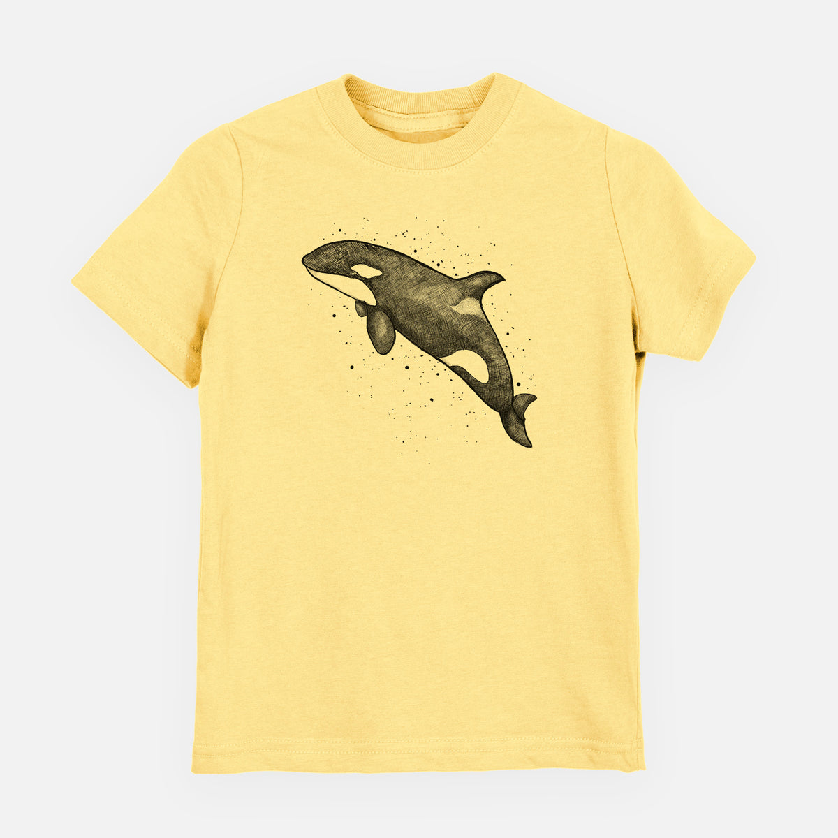 Butter yellow youth t-shirt laid flat, printed with a black ink illustration of an orca leaping, with ink splatters.