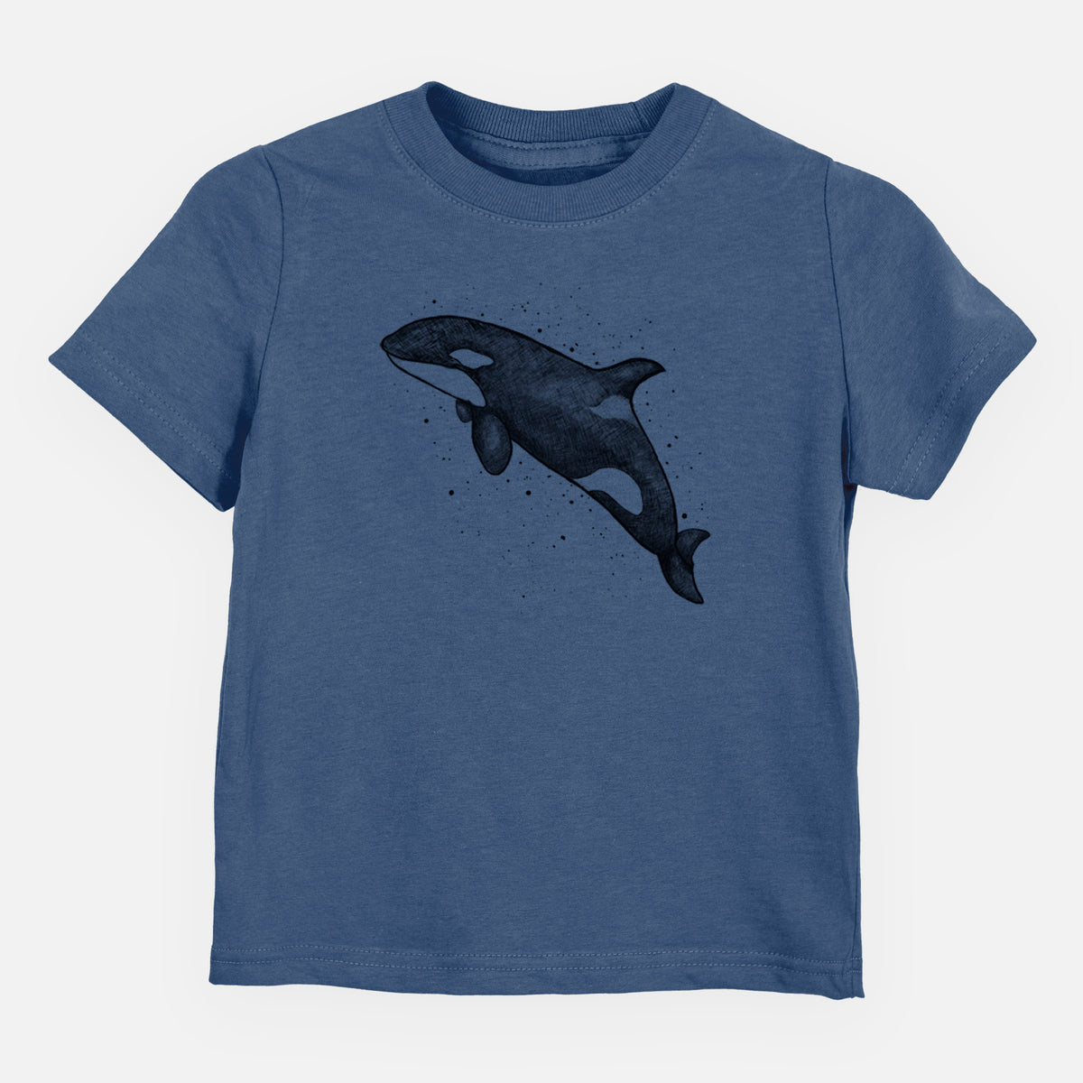 Indigo blue toddler t-shirt laid flat, printed with a black ink illustration of an orca leaping, with ink splatters.