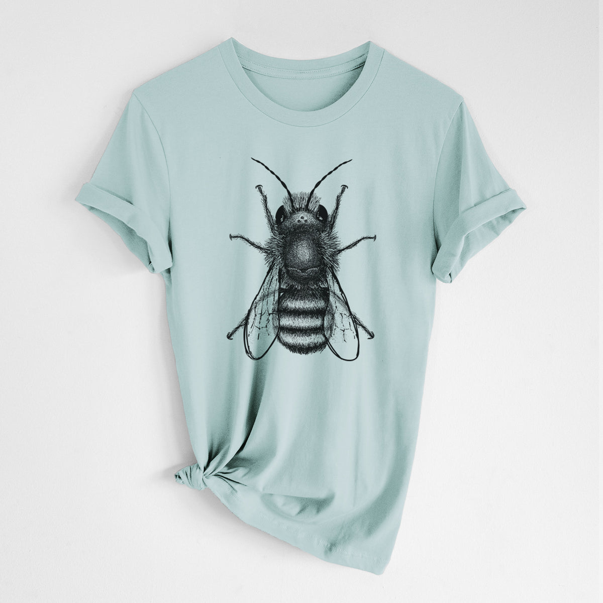 Dusty blue lightweight cotton t-shirt laid flat with the sleeves rolled, printed with a detailed black ink illustration of a red mason bee with its wings spread, seen from above.