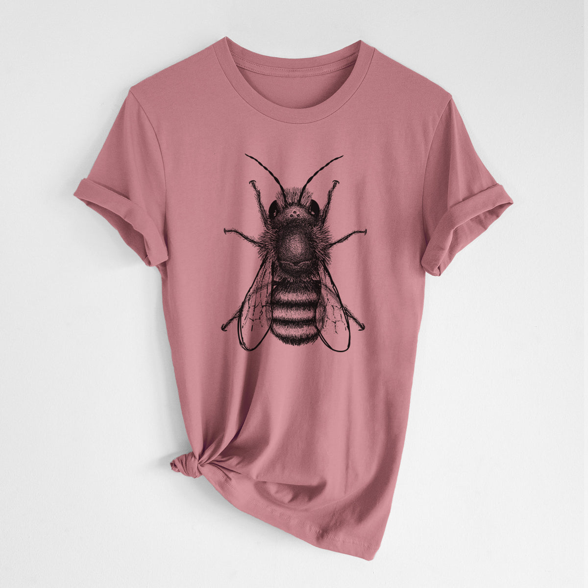 Mauve pink lightweight cotton t-shirt laid flat with the sleeves rolled, printed with a detailed black ink illustration of a red mason bee with its wings spread, seen from above.