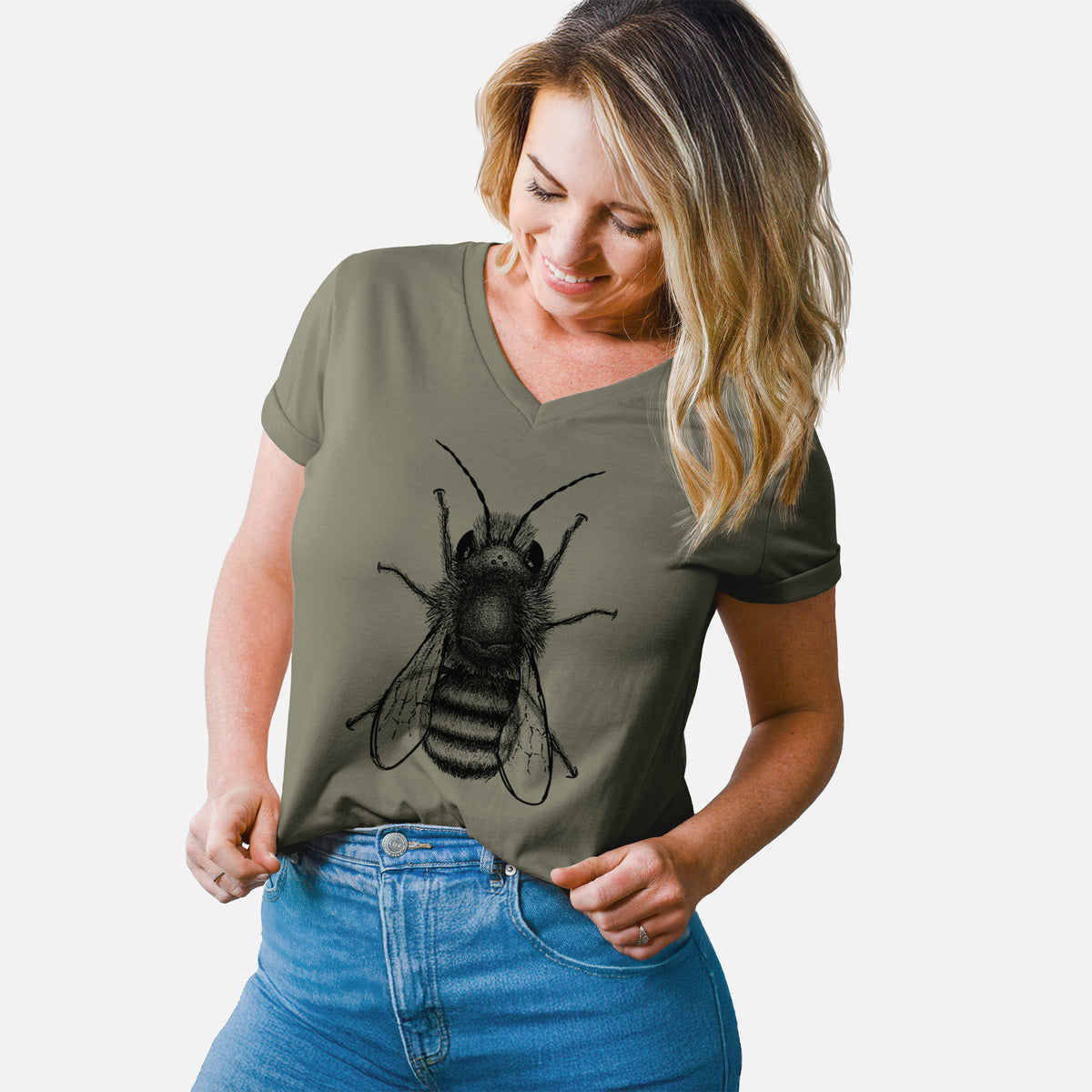 Woman wearing a military green women's relaxed fit cotton V-neck t-shirt printed with a detailed black ink illustration of a red mason bee with its wings spread, seen from above.