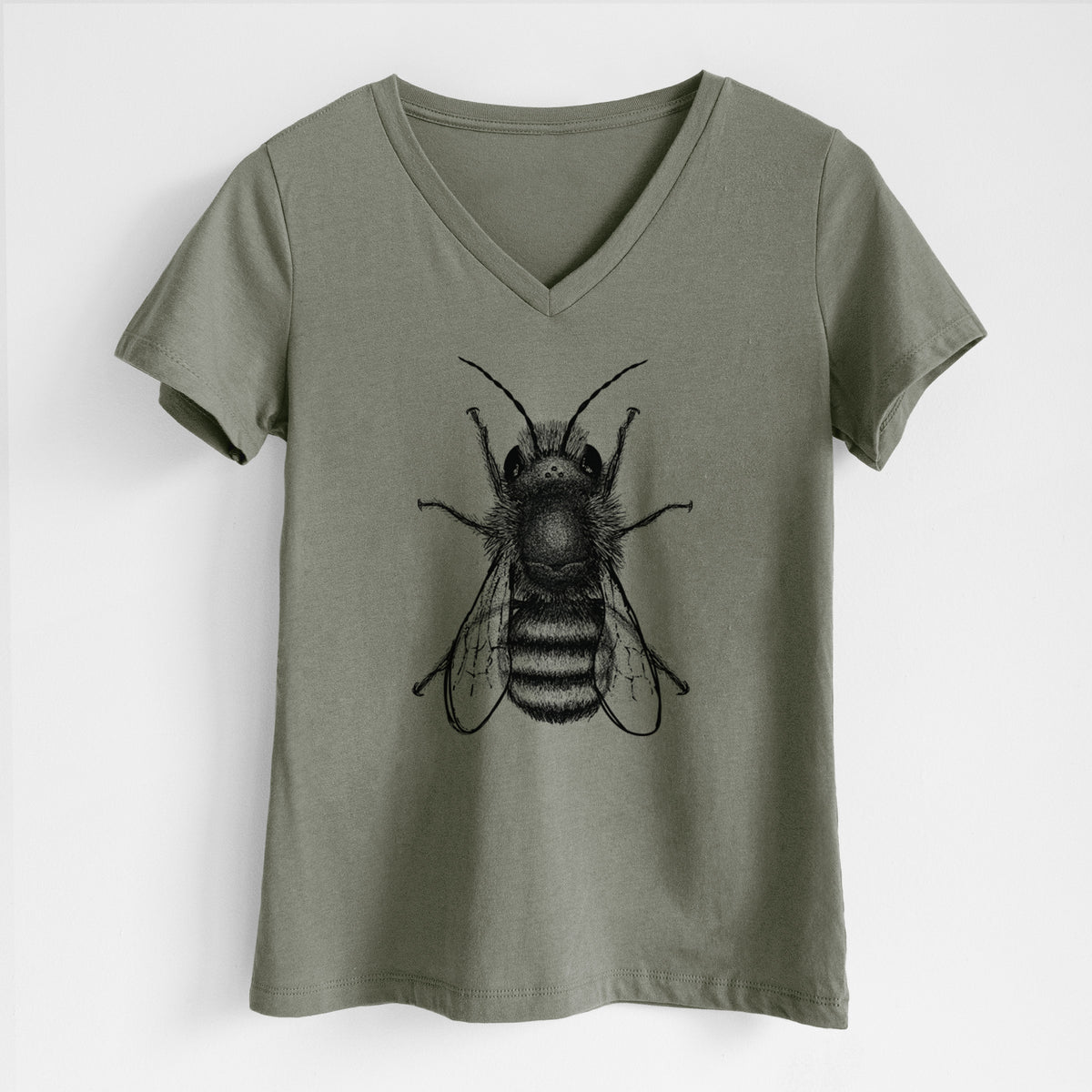 Military green women's relaxed fit cotton V-neck t-shirt laid flat, printed with a detailed black ink illustration of a red mason bee with its wings spread, seen from above.