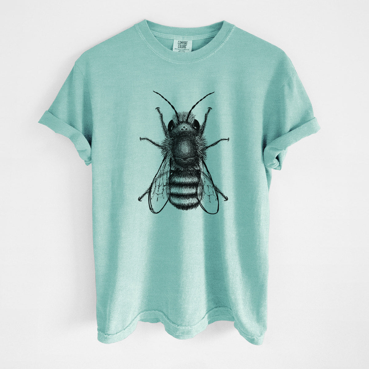 Chalky mint Comfort Colors t-shirt laid flat, printed with a detailed black ink illustration of a red mason bee with its wings spread, seen from above.