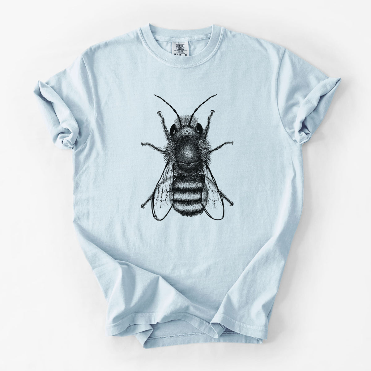 Chambray blue Comfort Colors t-shirt laid flat, printed with a detailed black ink illustration of a red mason bee with its wings spread, seen from above.