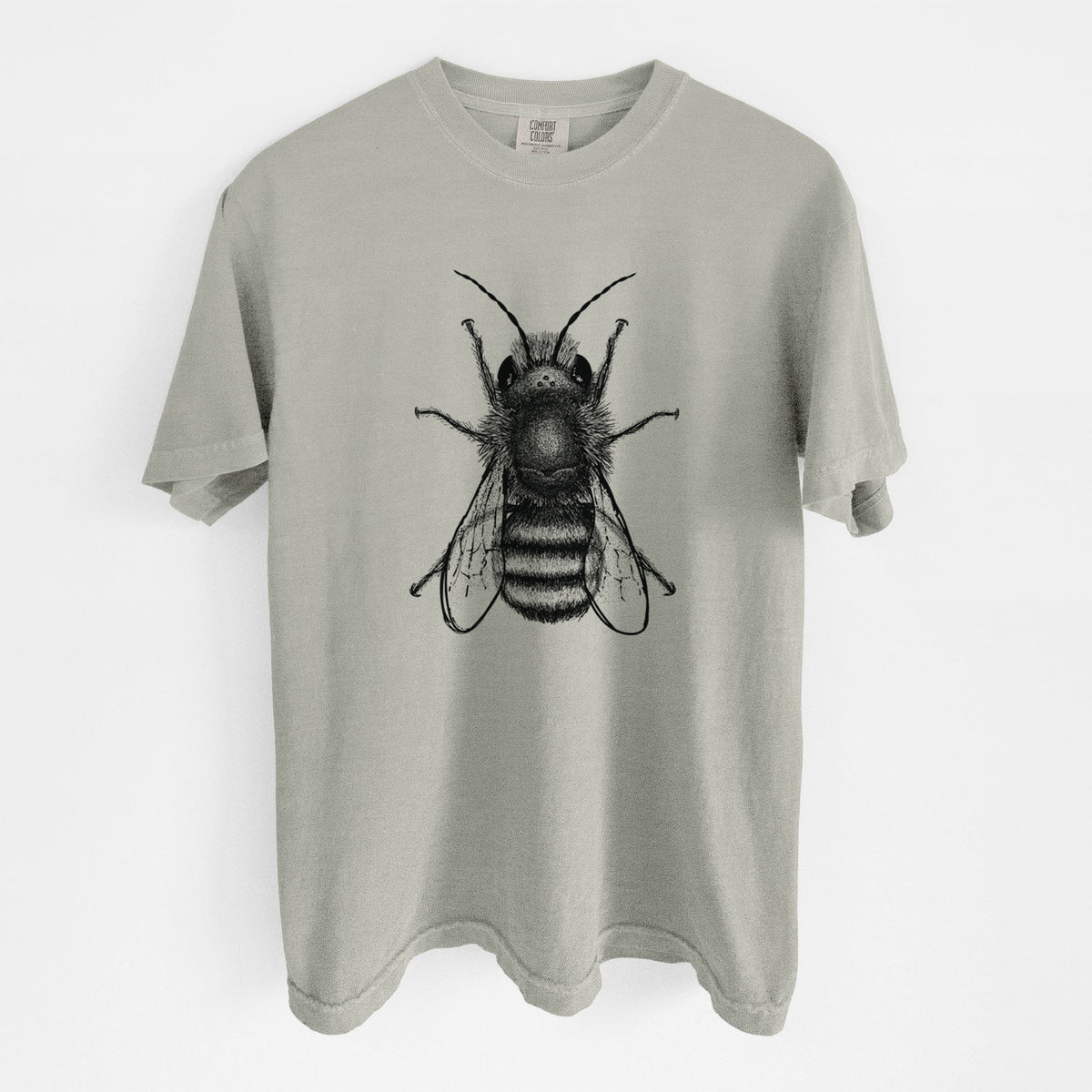 Sandstone beige Comfort Colors t-shirt laid flat, printed with a detailed black ink illustration of a red mason bee with its wings spread, seen from above.