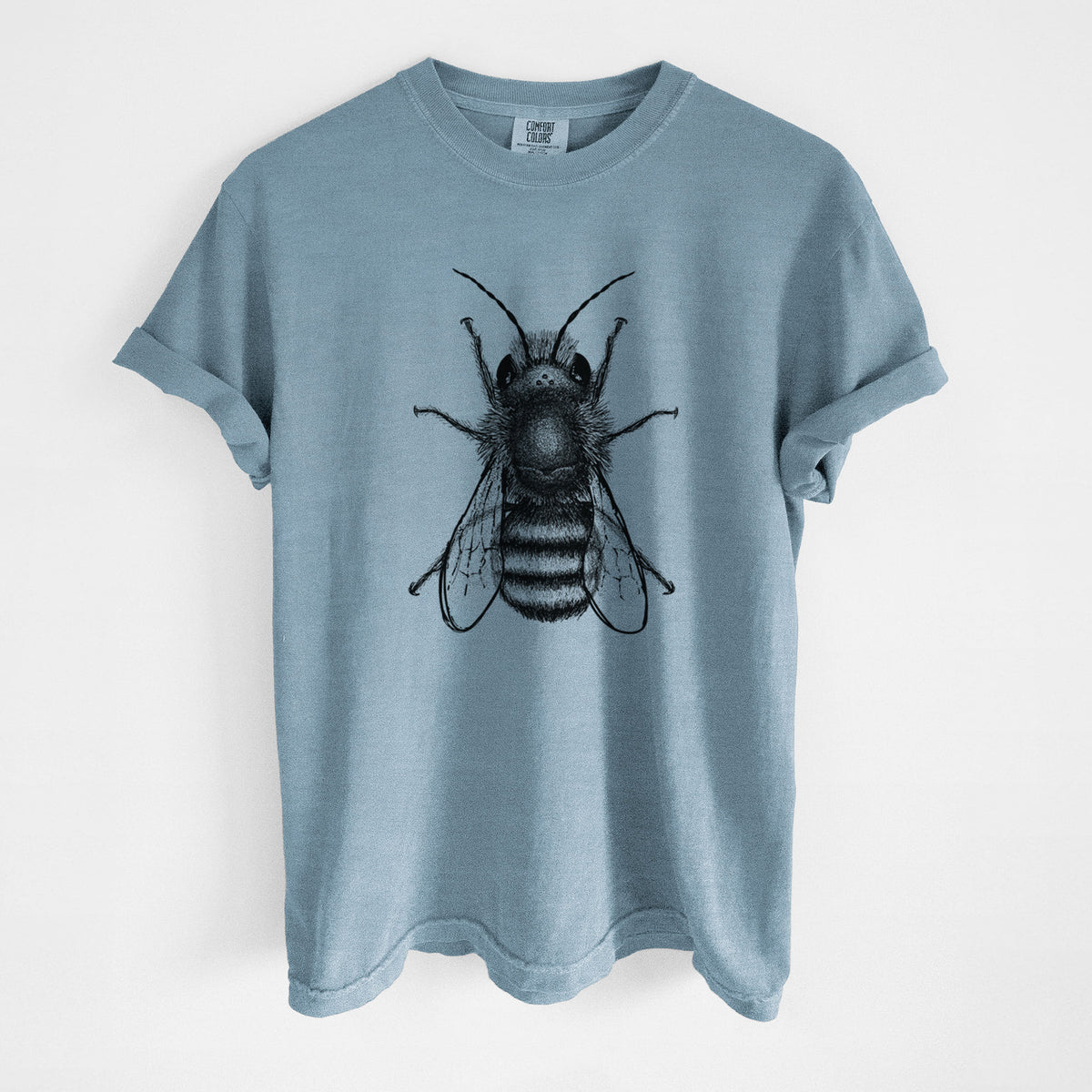 Steel blue Comfort Colors t-shirt laid flat, printed with a detailed black ink illustration of a red mason bee with its wings spread, seen from above.