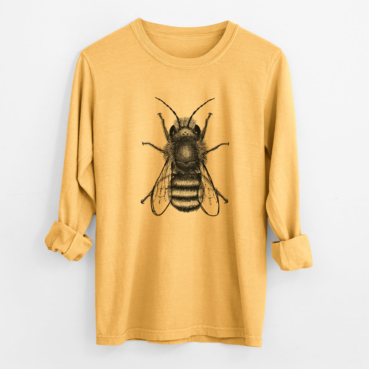 Golden wheat yellow Comfort Colors long sleeve shirt laid flat with the cuffs rolled, printed with a detailed black ink illustration of a red mason bee with its wings spread, seen from above.