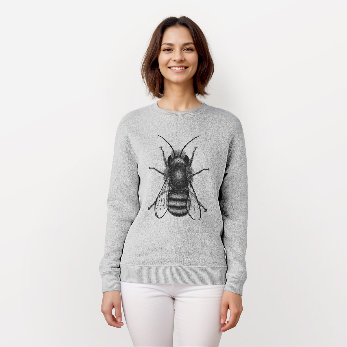 Woman wearing a knit sweatshirt printed with a detailed black ink illustration of a red mason bee with its wings spread, seen from above.