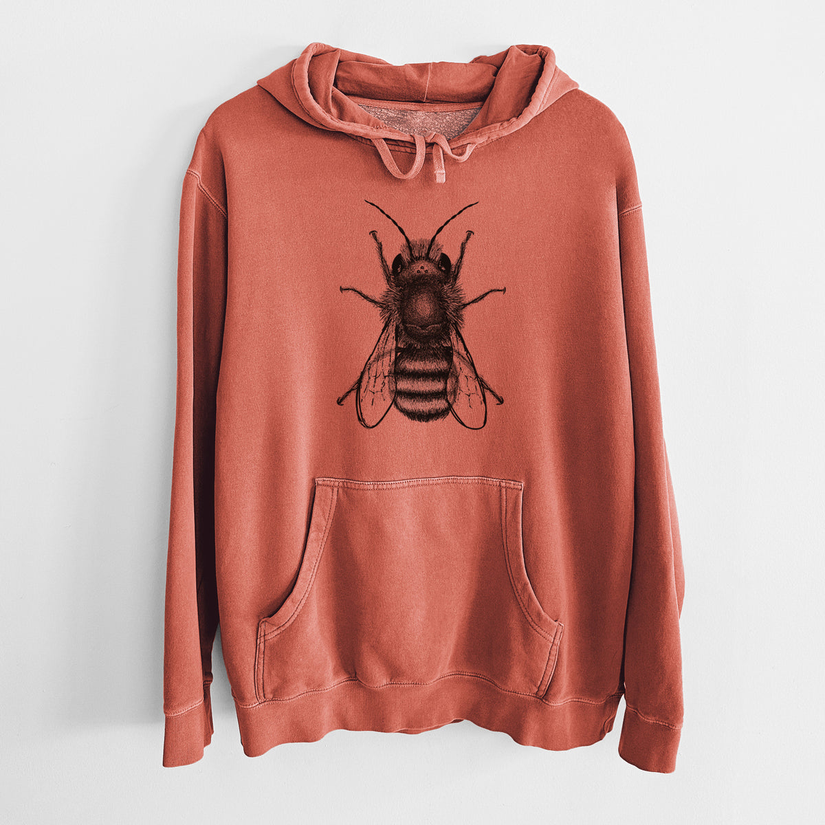 Amber orange pigment dyed hoodie laid flat, printed with a detailed black ink illustration of a red mason bee with its wings spread, seen from above.