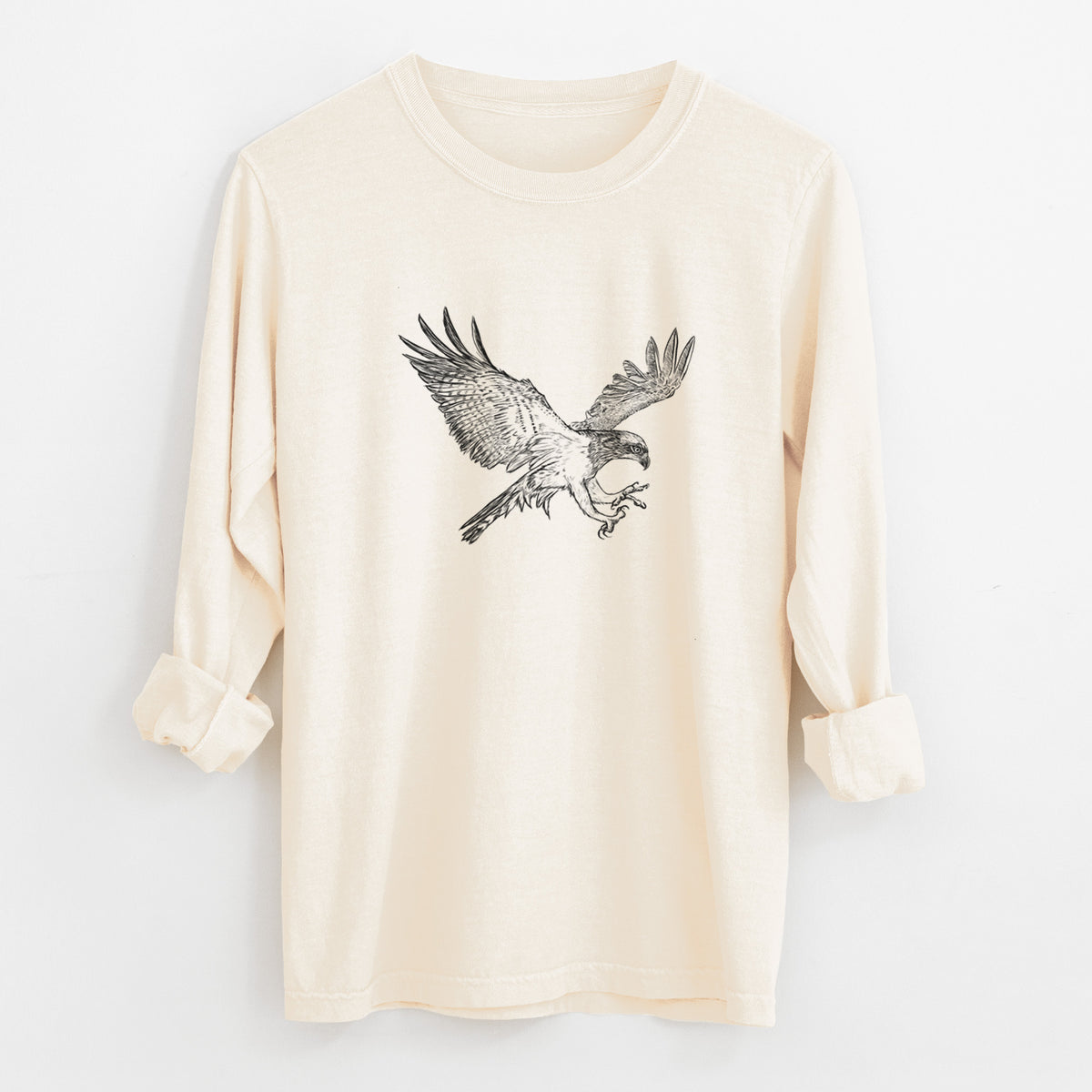 Ivory Comfort Colors long sleeve shirt laid flat with the cuffs rolled, printed with a black ink illustration of an osprey in flight with its wings spread.