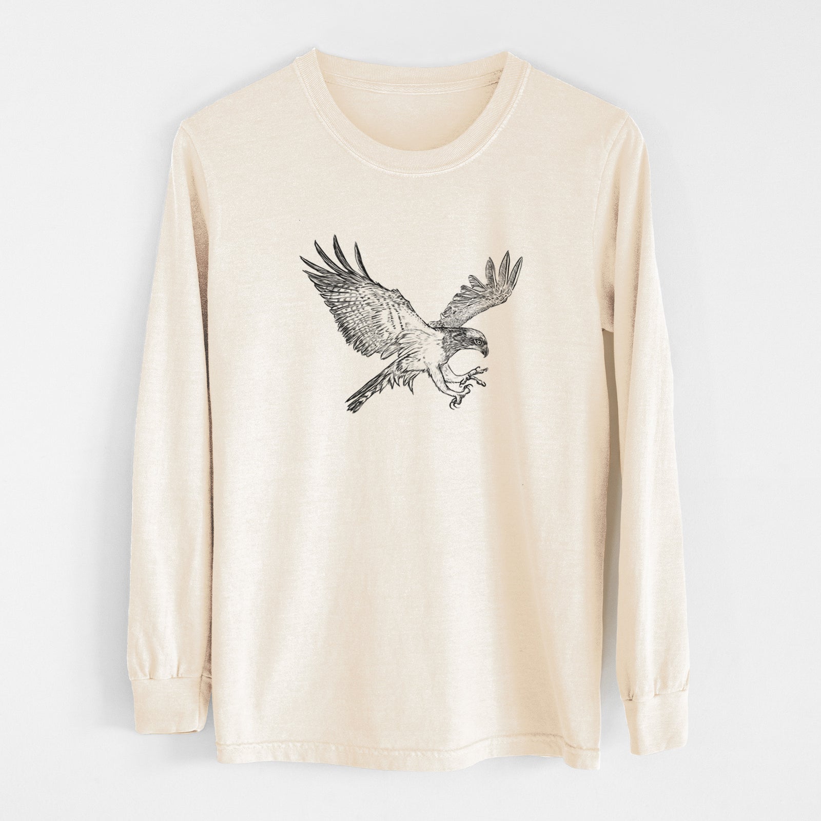 Ivory Comfort Colors long sleeve shirt laid flat, printed with a black ink illustration of an osprey in flight with its wings spread.