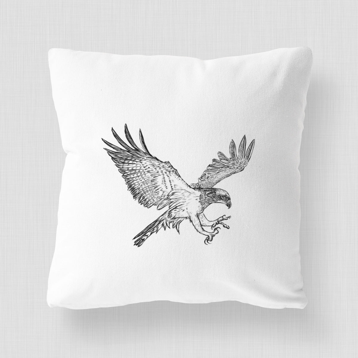 White pillow cover printed with a black ink illustration of an osprey in flight with its wings spread.