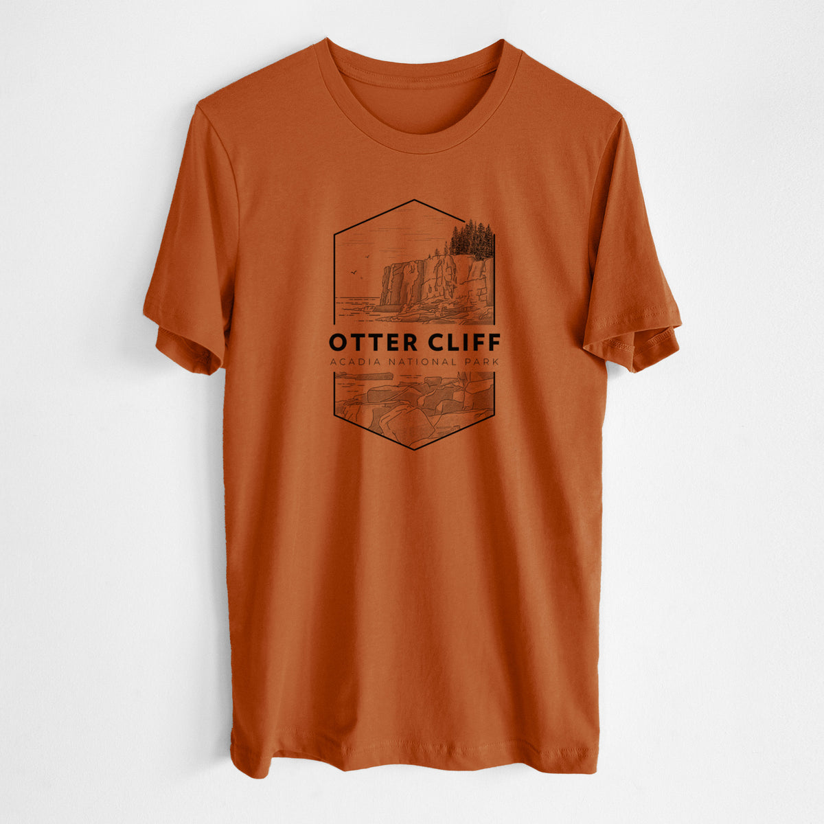 Autumn lightweight cotton t-shirt laid flat, printed with a black line art badge of Otter Cliff above the ocean, with the words Otter Cliff, Acadia National Park.