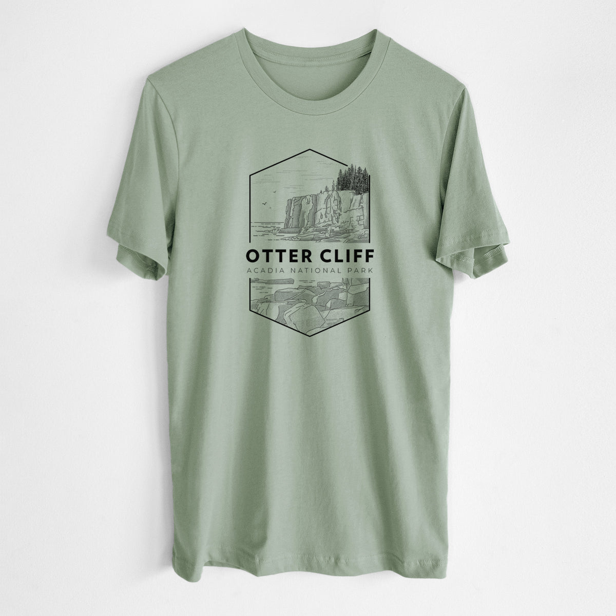 Sage green lightweight cotton t-shirt laid flat, printed with a black line art badge of Otter Cliff above the ocean, with the words Otter Cliff, Acadia National Park.