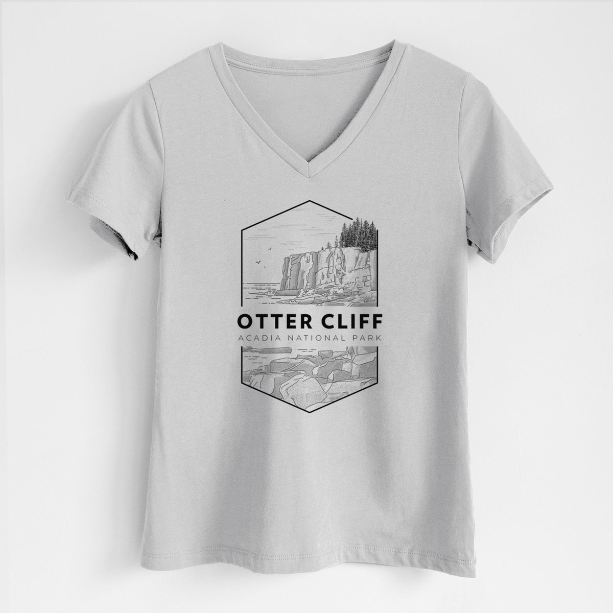 Lunar grey women's relaxed fit cotton V-neck t-shirt laid flat, printed with a black line art badge of Otter Cliff above the ocean, with the words Otter Cliff, Acadia National Park.