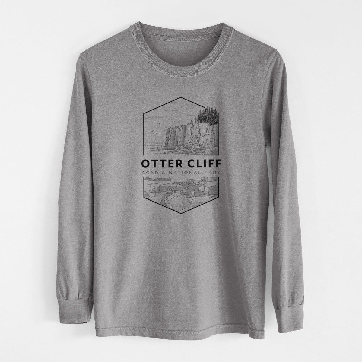 Grey Comfort Colors long sleeve shirt laid flat, printed with a black line art badge of Otter Cliff above the ocean, with the words Otter Cliff, Acadia National Park.