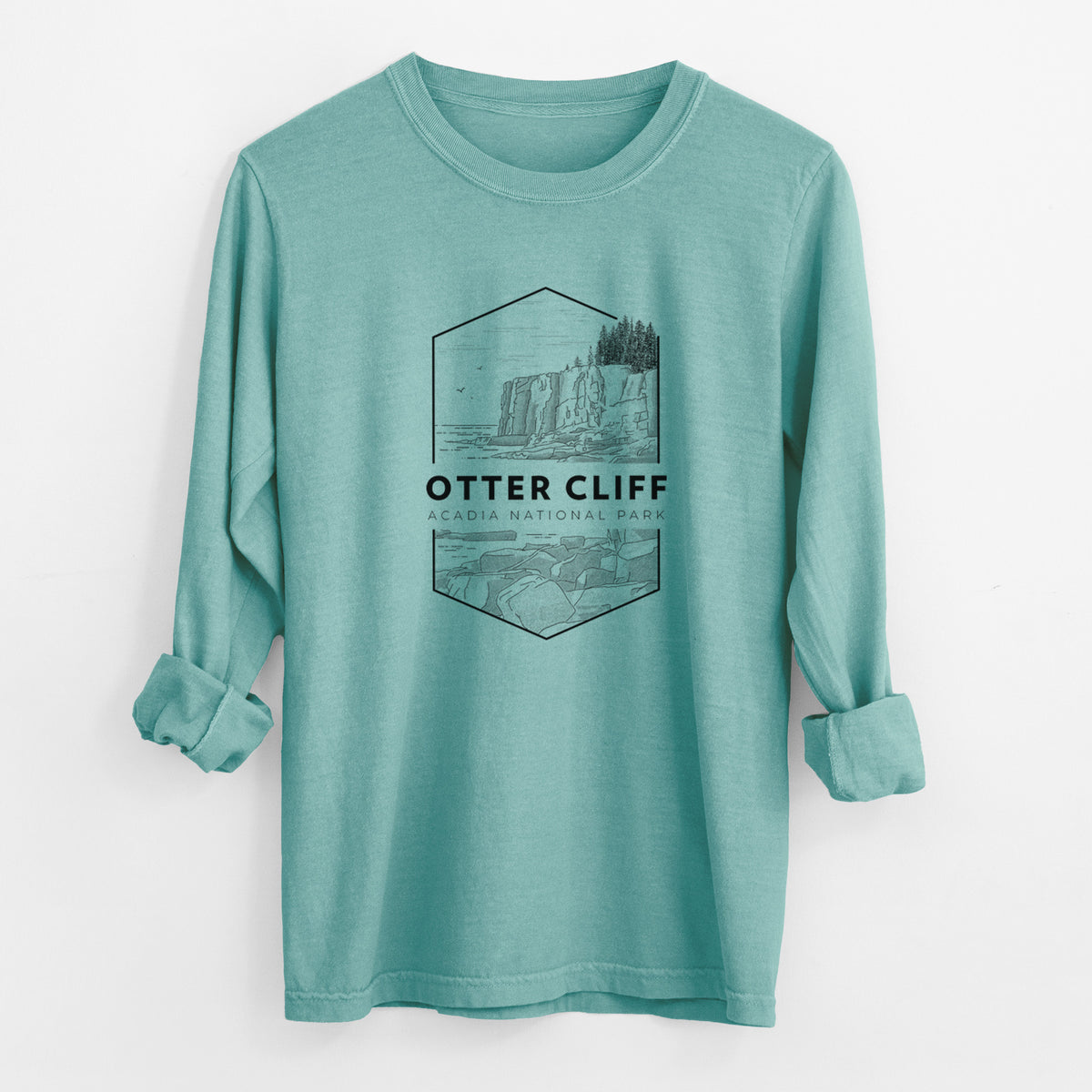 Reef green Comfort Colors long sleeve shirt laid flat with the cuffs rolled, printed with a black line art badge of Otter Cliff above the ocean, with the words Otter Cliff, Acadia National Park.