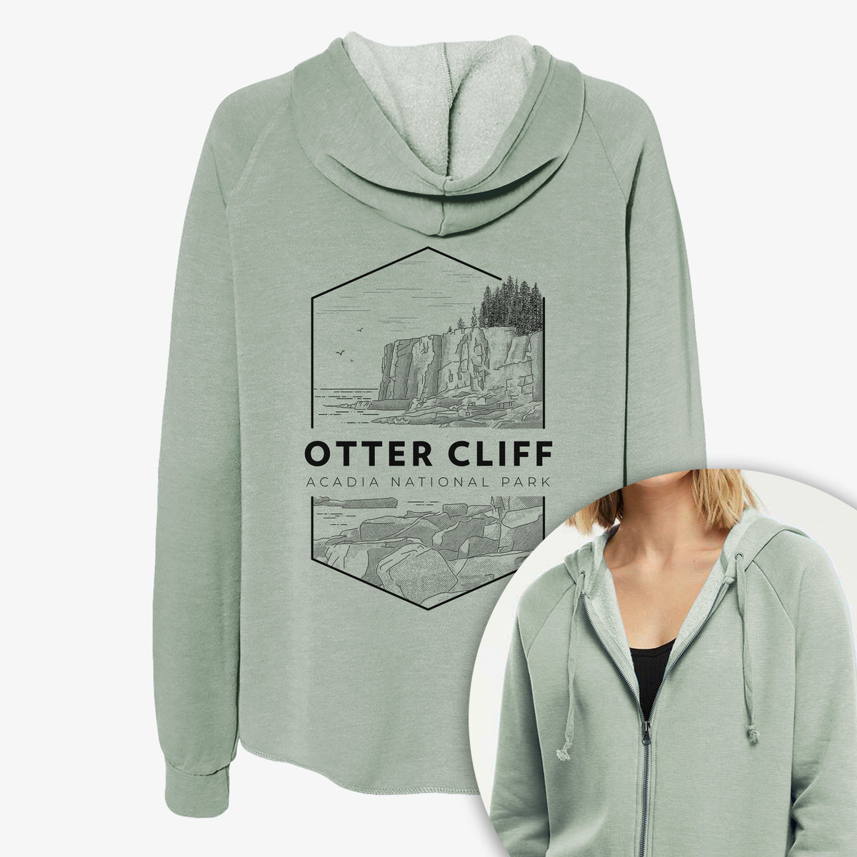 Women's Cali Wave zip-up sweatshirt printed with a black line art badge of Otter Cliff above the ocean, with the words Otter Cliff, Acadia National Park, with a close-up of the zipper.