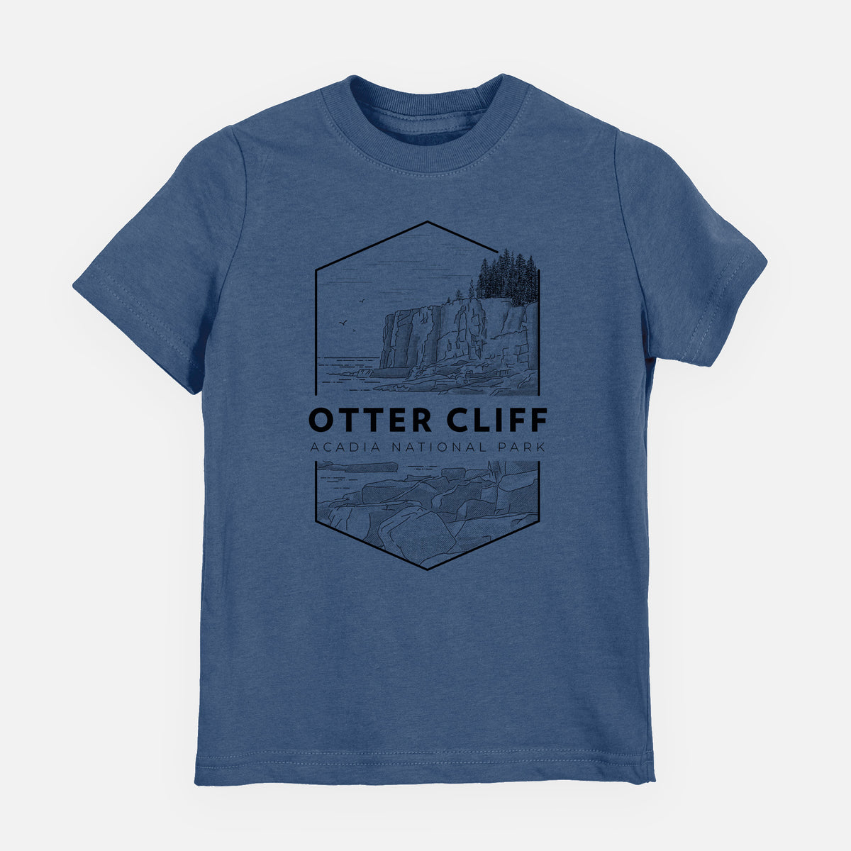 Indigo blue youth t-shirt laid flat, printed with a black line art badge of Otter Cliff above the ocean, with the words Otter Cliff, Acadia National Park.