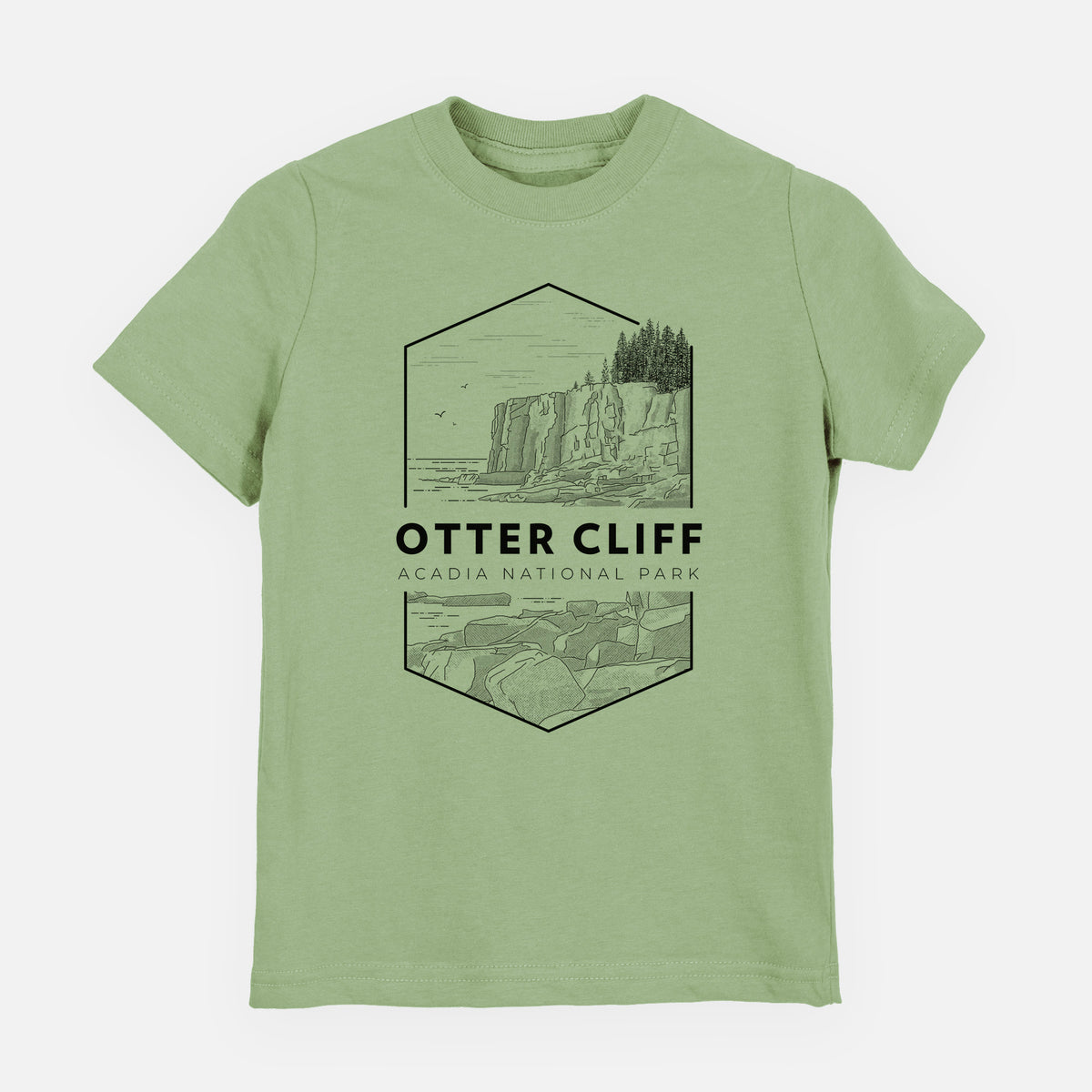 Sage green youth t-shirt laid flat, printed with a black line art badge of Otter Cliff above the ocean, with the words Otter Cliff, Acadia National Park.