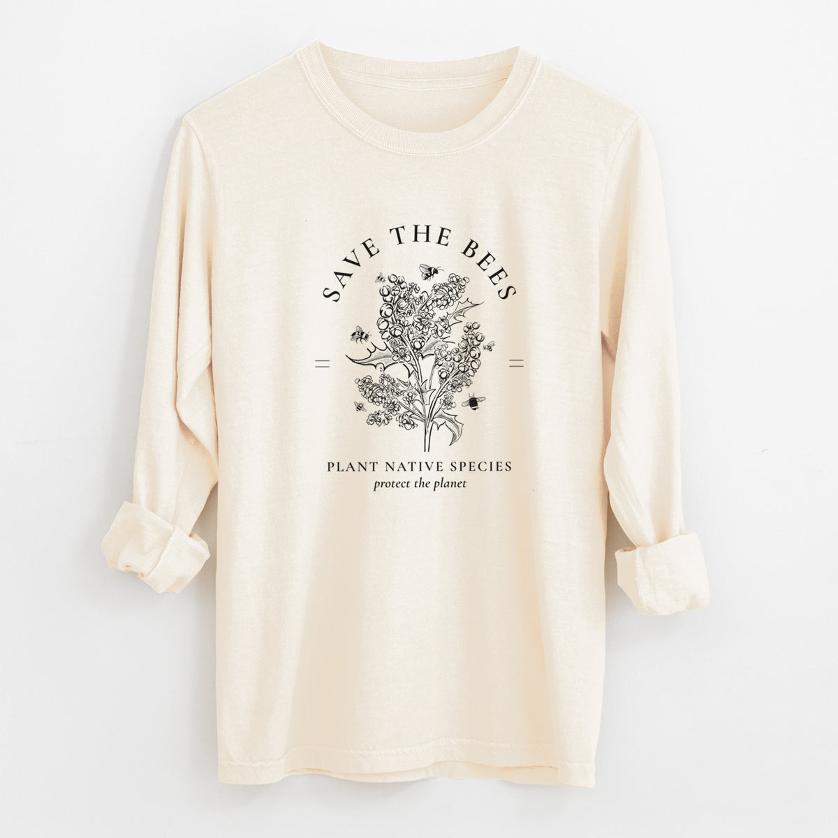 Ivory Comfort Colors long sleeve shirt laid flat with the cuffs rolled, printed with a black ink wildflower bouquet with bees, framed by the words Save the Bees, Plant Native Species.