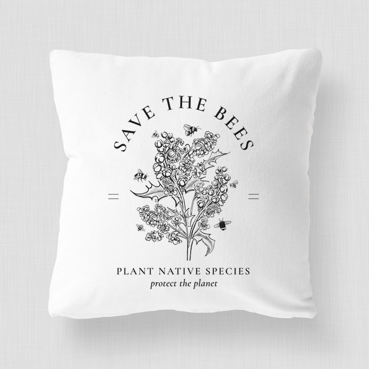 White pillow cover printed with a black ink wildflower bouquet with bees, framed by the words Save the Bees, Plant Native Species.