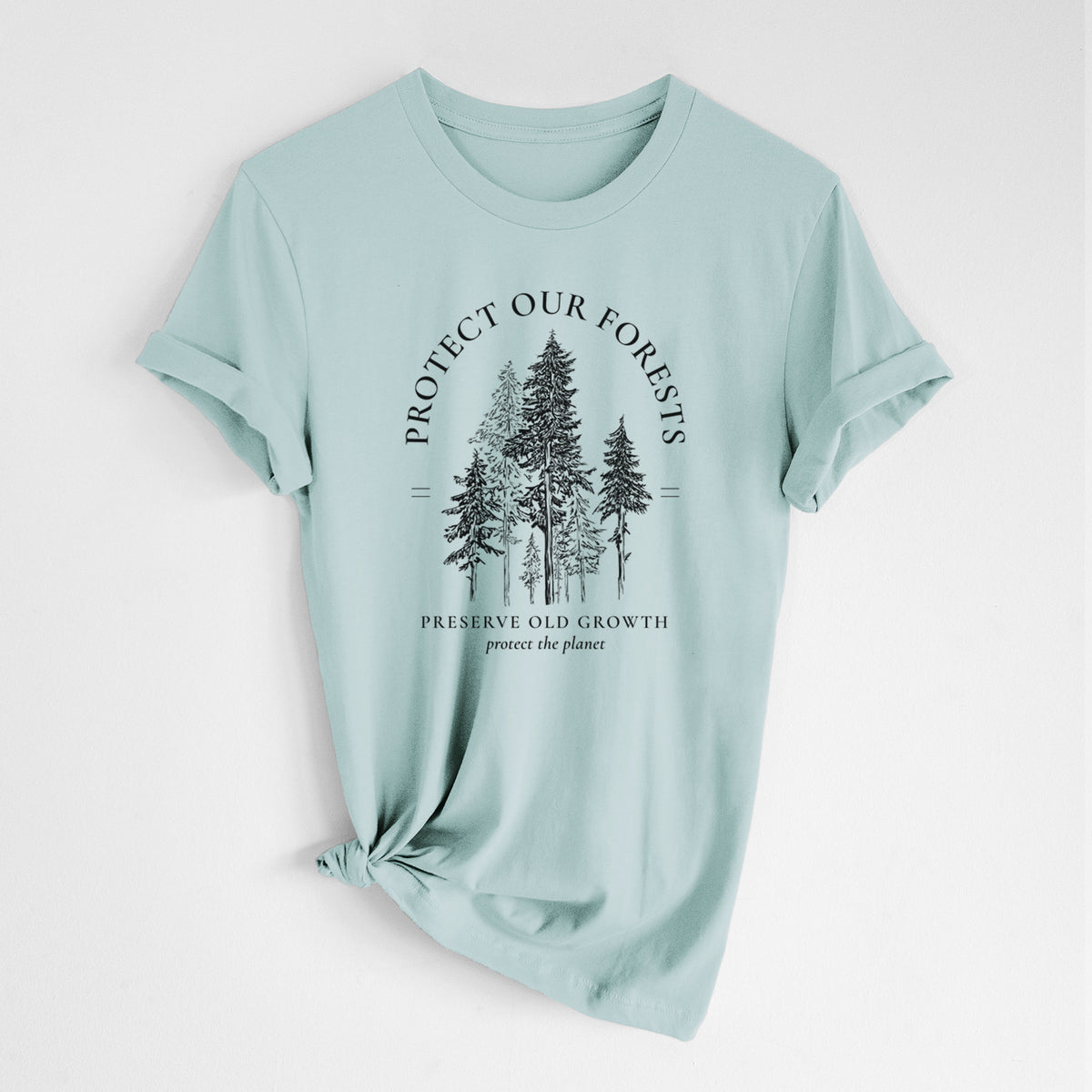 Dusty blue lightweight cotton t-shirt laid flat with the sleeves rolled, printed with a black ink illustration of a stand of tall pine trees, framed by the words Protect Our Forests, Preserve Old Growth.