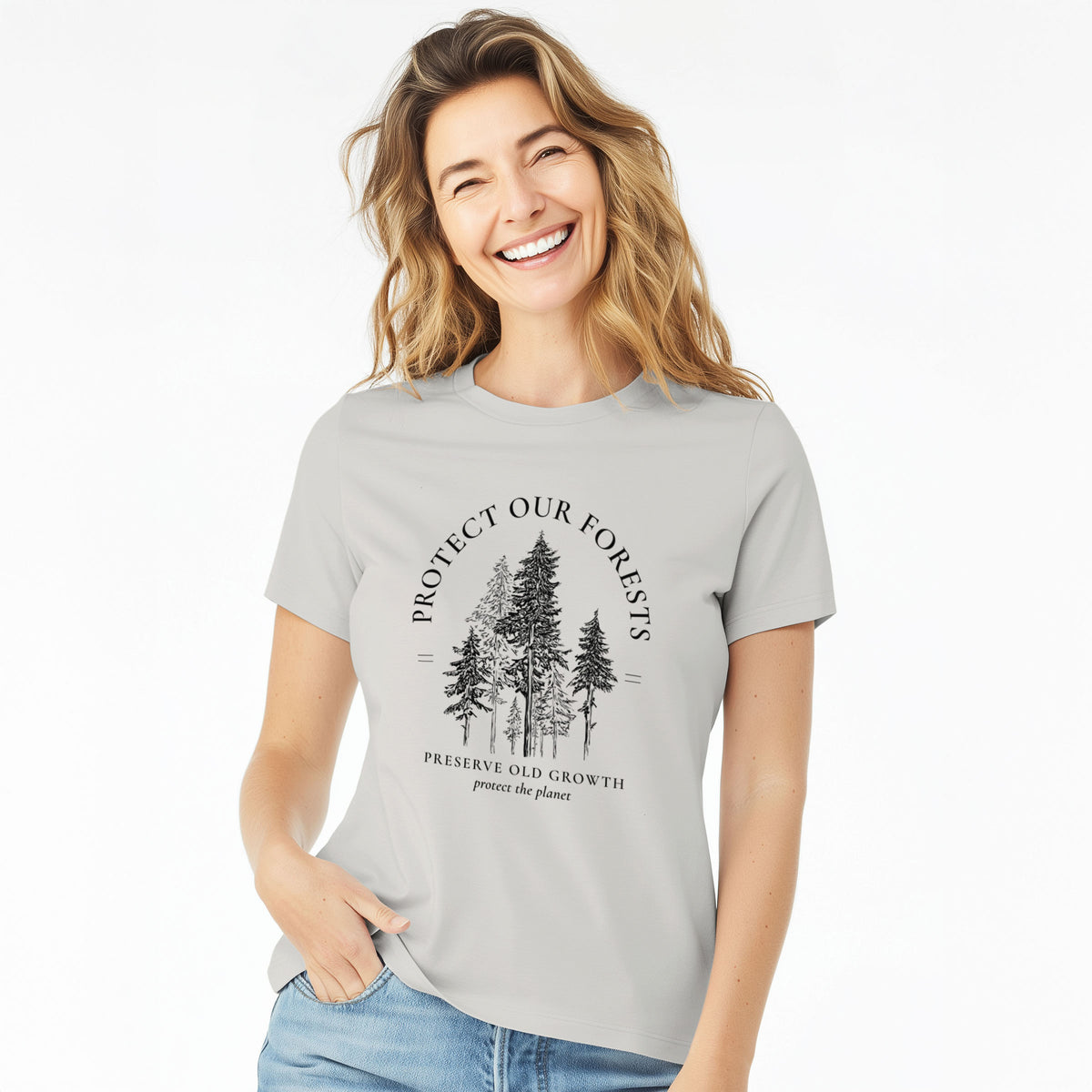 Woman wearing a lunar grey women's relaxed fit cotton t-shirt printed with a black ink illustration of a stand of tall pine trees, framed by the words Protect Our Forests, Preserve Old Growth.