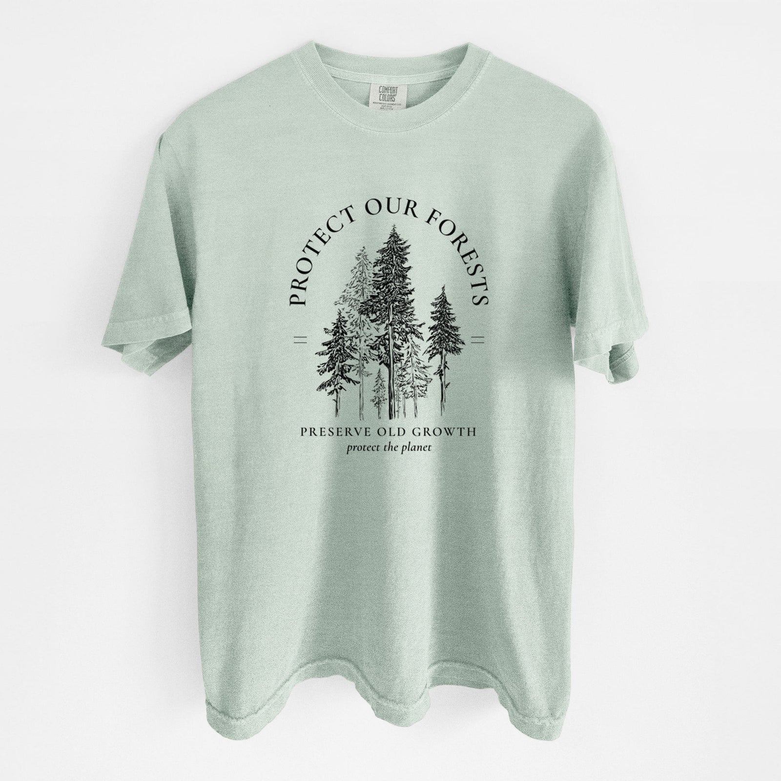 Blue jean Comfort Colors t-shirt laid flat, printed with a black ink illustration of a stand of tall pine trees, framed by the words Protect Our Forests, Preserve Old Growth.