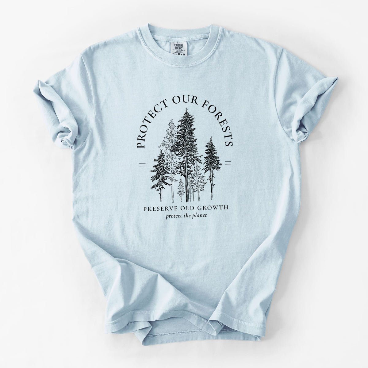 Chambray blue Comfort Colors t-shirt laid flat, printed with a black ink illustration of a stand of tall pine trees, framed by the words Protect Our Forests, Preserve Old Growth.