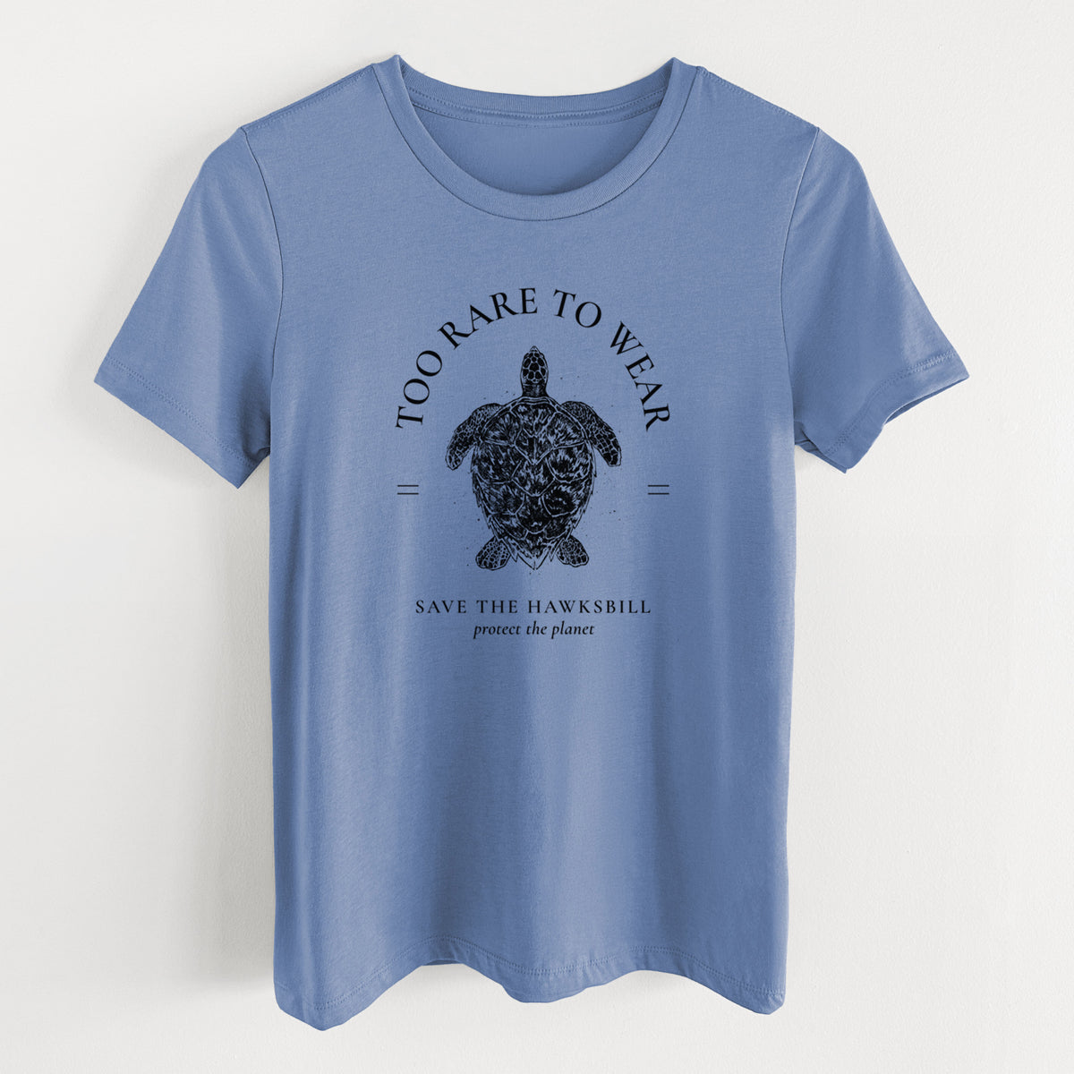 Blue bell women's relaxed fit cotton t-shirt laid flat, printed with a black ink hawksbill sea turtle framed by the words Too Rare to Wear, Save the Hawksbill.