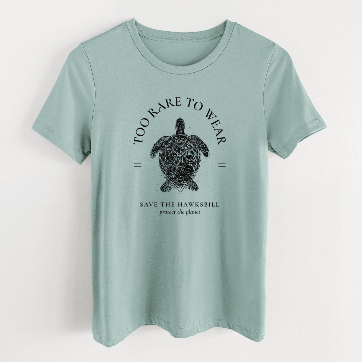 Dusty blue women's relaxed fit cotton t-shirt laid flat, printed with a black ink hawksbill sea turtle framed by the words Too Rare to Wear, Save the Hawksbill.